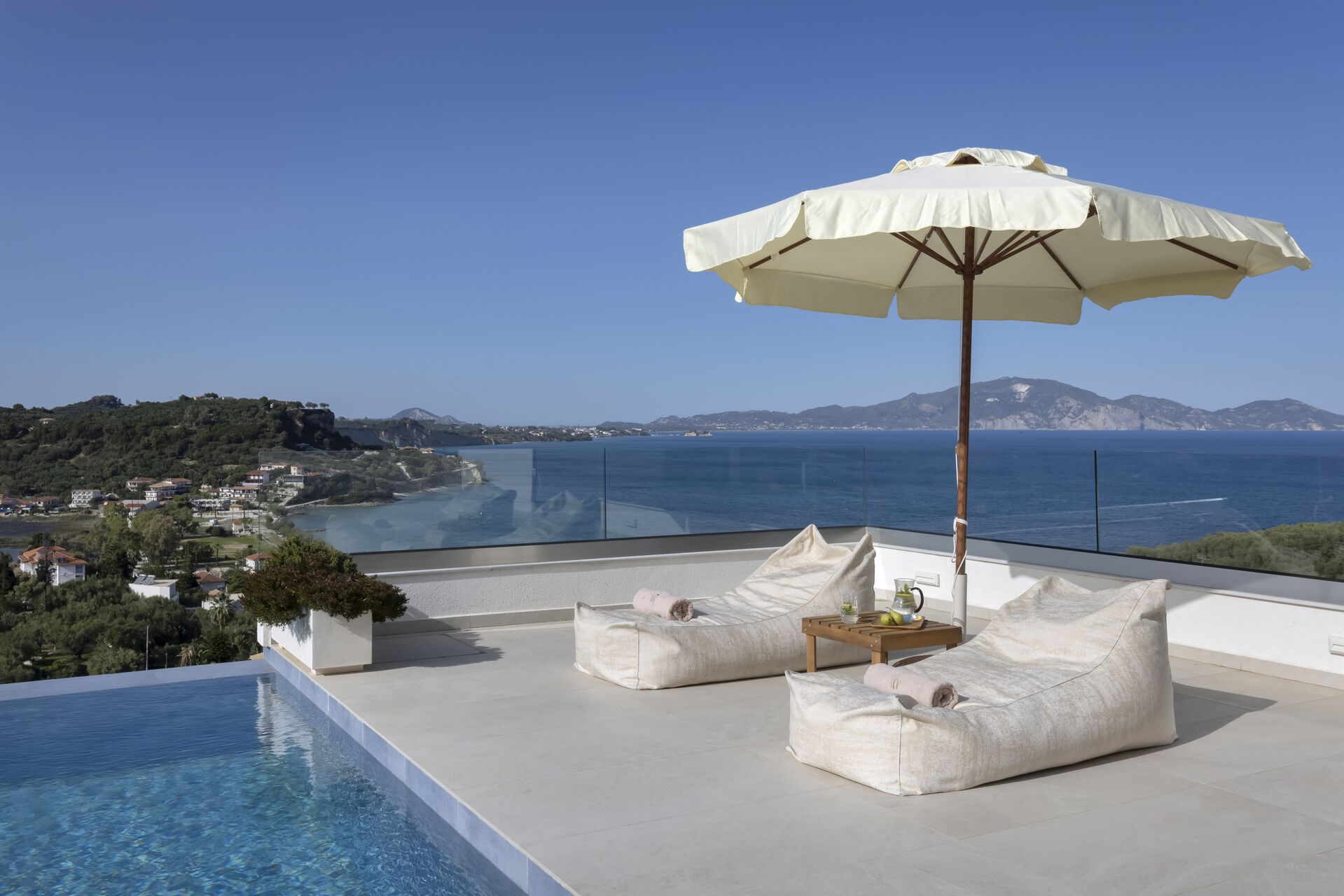 The villa's infinity pool, its edge blending seamlessly into the view of Keri Bay.