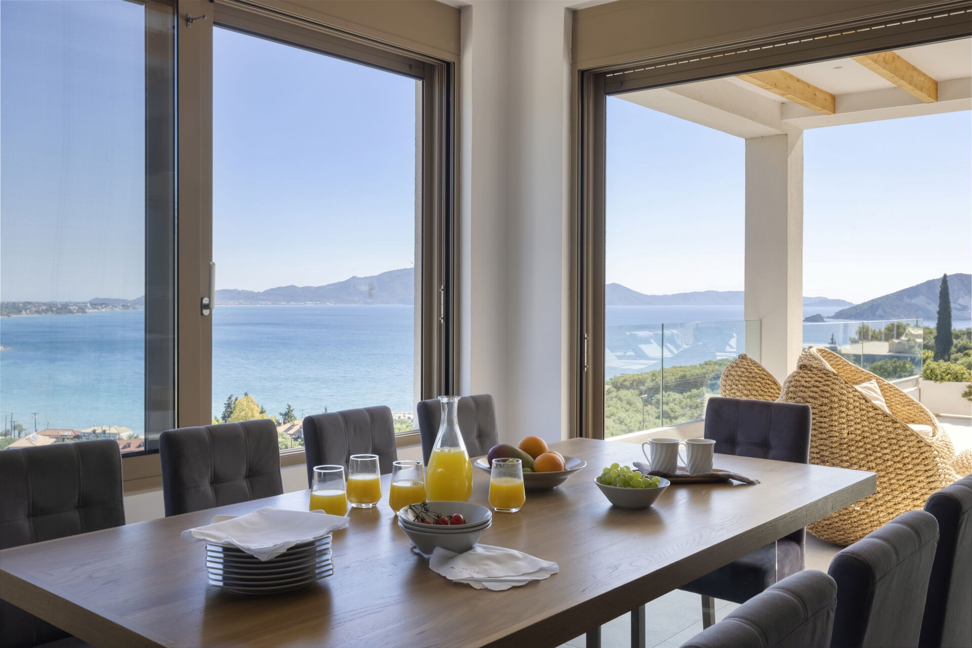 A terrace table set for guests, framed by the views across Keri Bay.