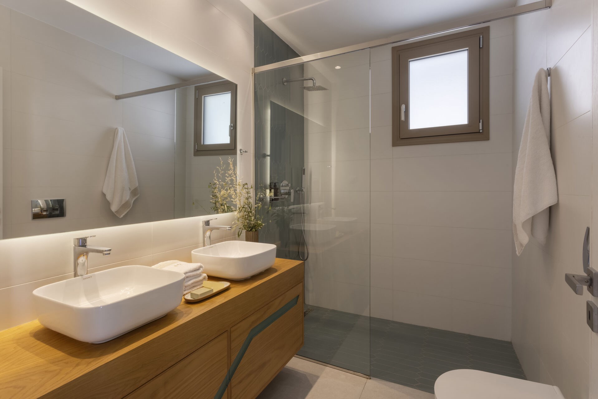 A modern en-suite shower room, finished in soft, natural materials.