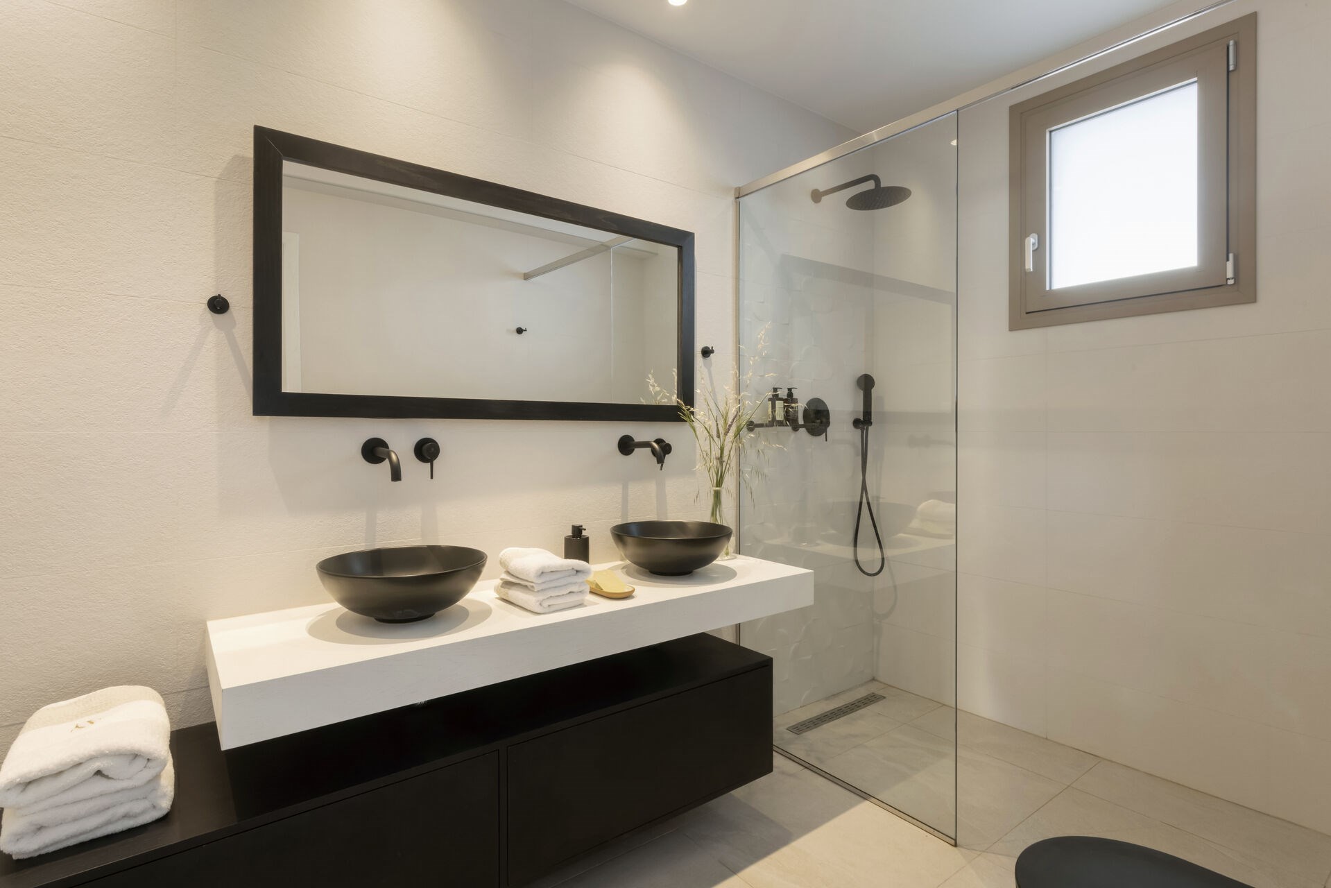 A modern en-suite shower room, finished in soft, natural materials.